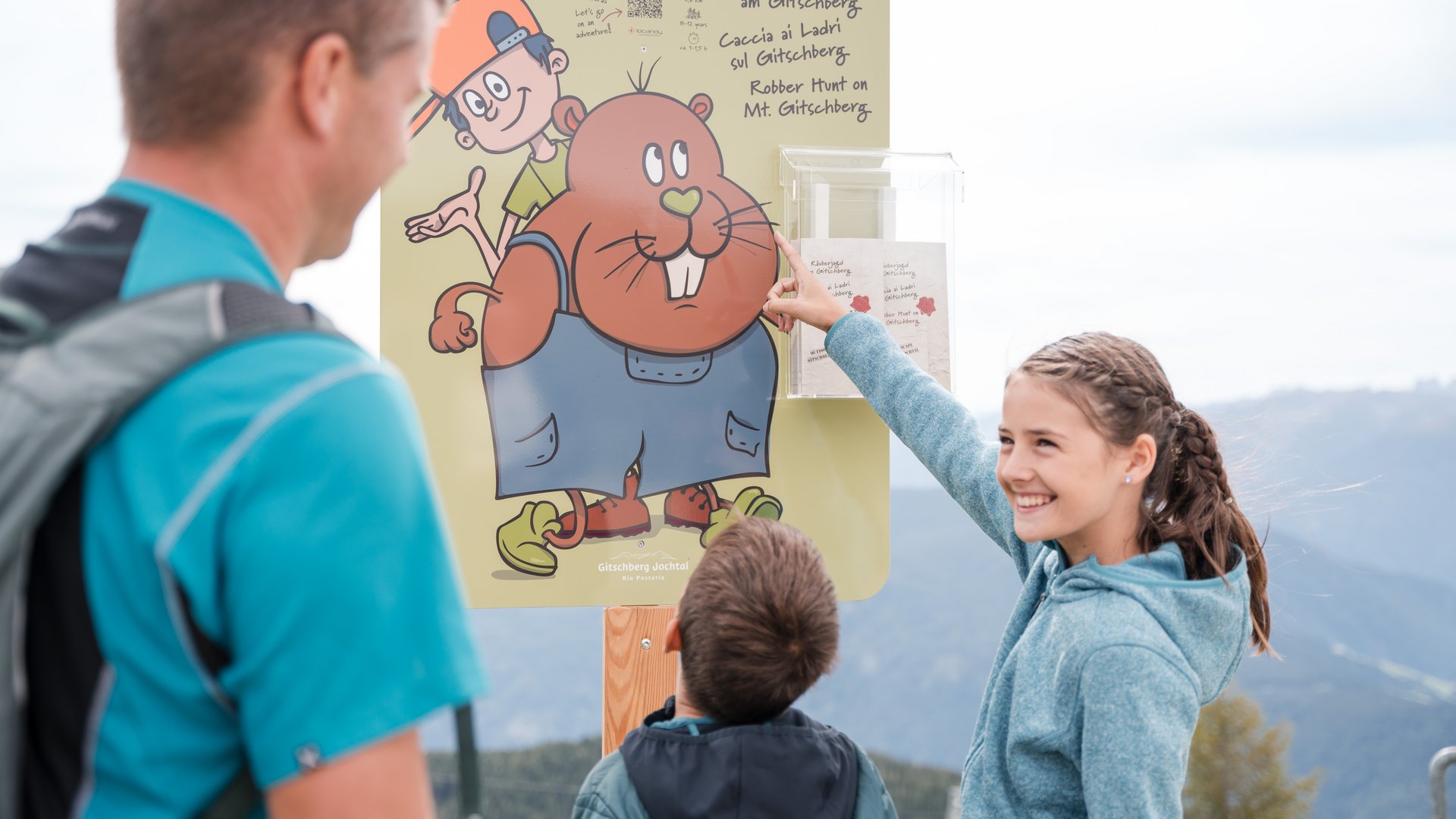Outdoor Escape on Mt. Gitschberg Family reading sign for robber hunt on Mt. Gitschberg outdoors