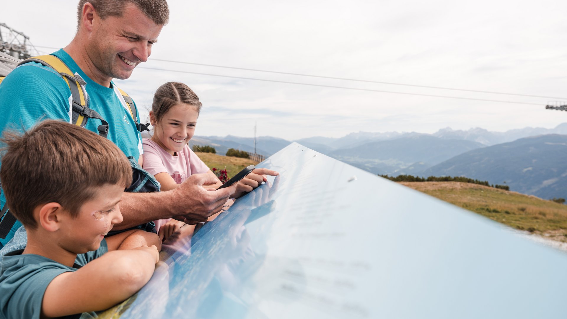 Outdoor Escape on Mt. Gitschberg Family reading informational sign outdoors in the mountains