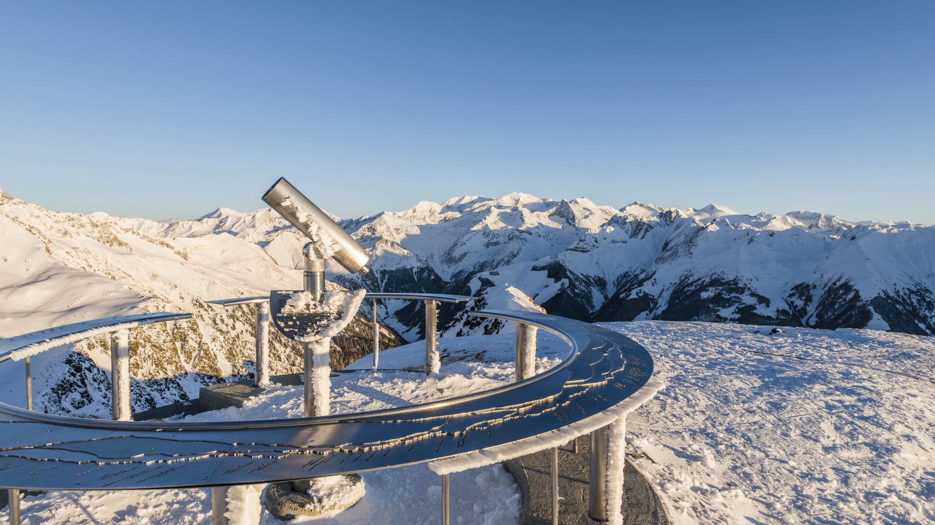 The Gitschberg panoramic platform in Meransen, Italy Telescope on snowy mountain peak overlooking snow-covered Alps