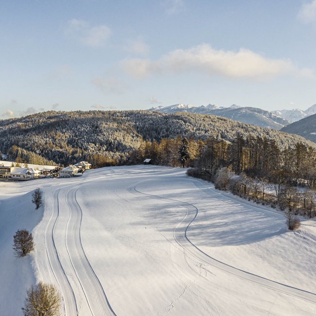 Cross-country skiing in Italy: discover Gitschberg Jochtal Snow-covered landscape with mountains and forest in winter