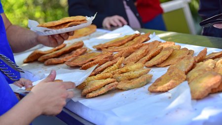 The eco-friendly way to enjoy South Tyrol Various fried dough pockets on a market stall