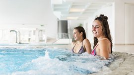 Der Alpinpool in Meransen Zwei junge Frauen in einem Schwimmbecken