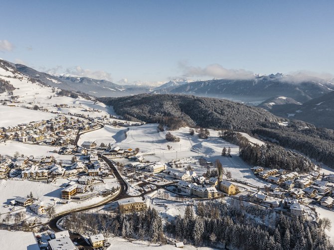 The Alpine hamlet of Spinges Winter scene of a snow-covered village in a valley with mountains in the background