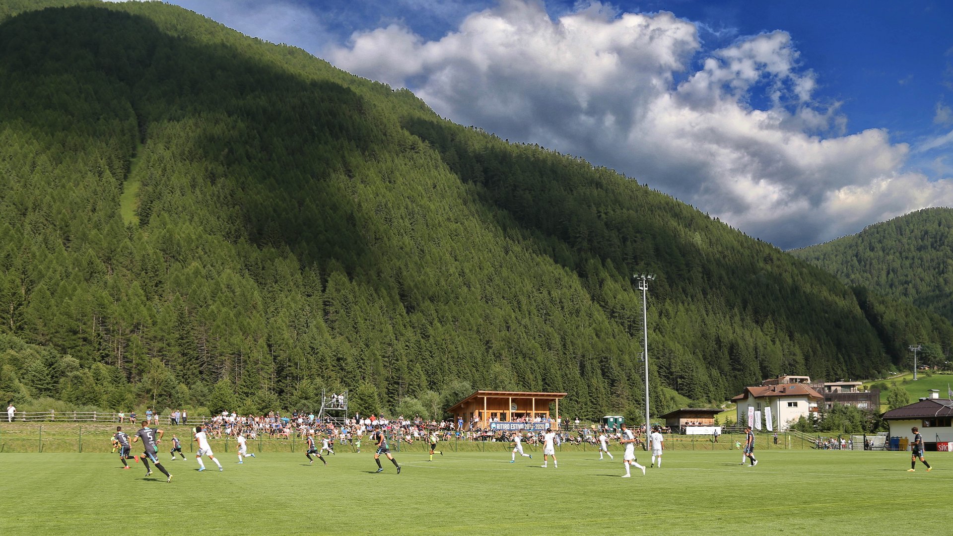 Trainingslager Bologna FC 1909 Man sieht ein Fußballspiel auf einem Fußballplatz. Dahinter hügelige Landschaft.